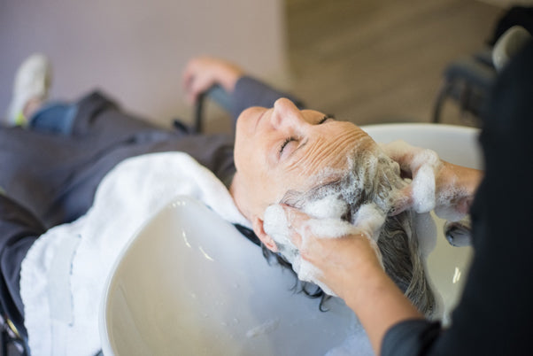 a person having their hair washed in a salon sink  | areen1